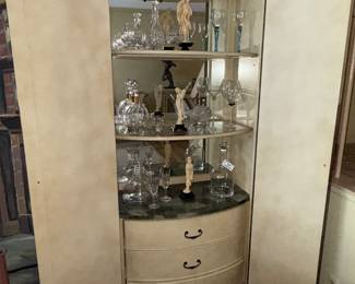 Curio cabinet with glass and crystal wine glasses and decanters