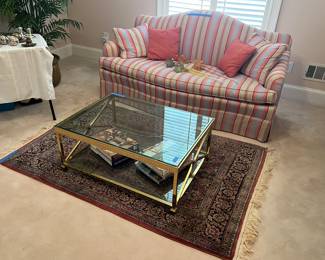 Settee, Murano glass flowers, glass top coffee table, rug, books