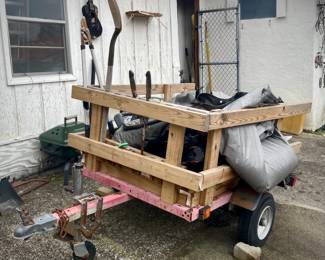 Custom-built utility trailer with wooden frame and various tools