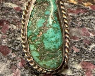 a large and chunky turquoise silver ring.