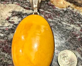 Size comparison of the egg yolk, amber pendant