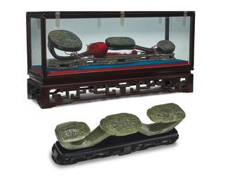 3162
Two Chinese carved jade Ruyi scepters
20th century
Comprising one carved with Taotie masks and foliate motifs, set on a hardwood stand, housed in a fitted cloth-clad box, and one carved wood scepter mounted with jade carved with elephant, a guardian lion, and a vase with flowers, housed in a glazed wood display case, set in a fitted wood storage box
2 pieces
Smaller: 2.5" H x 13.25" W x 2.75" D; Larger: 3.625" H x 19.25" W x 4.625" D
Estimate: $300 - $500