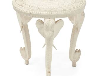 3323
An Anglo-Indian-style white painted occasional table
20th century
The white painted carved wood table raised on three elephant-form legs, the tabletop carved with elephant and floral motifs centering a foliate border
23.5" H x 22.5" Dia.
Estimate: $200 - $300