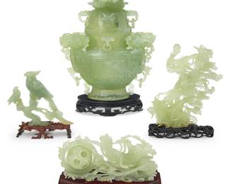 3165
A group of Chinese jade carvings
20th century
Comprising a maiden with flowing robes and puzzle ball articulated with three concentric spheres, a bird figural group, a fish and netting seascape group, and a lidded urn with Toatie mask designs, dragon-form handles, ring accents, and a Bixi finial, set in a custom cloth-clad fitted box
4 pieces
Urn: 13.75" H x 10.5" W x 3.75" D; Box: 5.625" H x 20.625" W x 13" D; Puzzle ball: 8.75" L
Estimate: $300 - $500