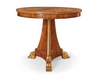 3103
A Burton-Ching English Regency-style center table
Late 20th/early 21st century
The table with burlwood veneer top, raised on a tripartite pedestal base with three giltwood stylized paw feet
31.25" H x 36" Dia.
Estimate: $200 - $300