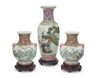 3140
Three Chinese Famille Rose porcelain vases
20th century
Each bearing an apocryphal reign mark for Qianlong Period (1735-1796); The tallest with Chinese inscription to body
Comprising a tall vase and a pair of shorter vases with opposed mask and ring accents, each set on a wood stand
3 pieces
Tall: 12.125" H x 5.125" Dia.; Pair: 6.75" H x 5.375" W x 5" D
Estimate: $100 - $200