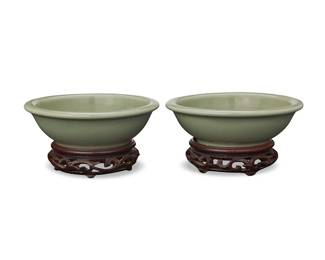 3128
Two Chinese Longquan celadon bowls
Ming Dynasty (1368-1644) or later
Each with molded fish decoration to well, set on a carved wood stand
2 pieces
Each bowl: 1.875" H x 5.75" Dia.; Each stand: 1.25" H x 3.875" Dia.
Estimate: $500 - $700