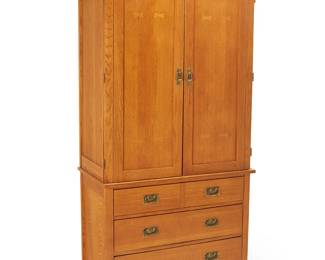 3307
A Contemporary Mission-style wardrobe
Early 21st century
Lower console with burn mark to upper drawer interior: Bassett / Made in USA; each numbered with factory stencil verso
The wood wardrobe with brass hardware, comprising an upper console with two hinged cabinet doors revealing two adjustable shelves, a sliding shelf, and a single drawer, above a lower console with five drawers
2 pieces
Upper console: 47.5" H x 38.25" W x 20.25" D; Lower console: 30.5" H x 38.25" W x 20.25" D
Estimate: $150 - $250