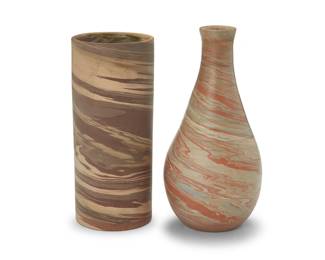 3310
Two Niloak pottery 'Mission Swirl' vases
Early/mid-20th century; Eagle Pottery Company, Benton, AR
One impressed: Niloak; the other unmarked
Comprising one cylindrical and another with attenuated neck
2 pieces
Cylindrical: 8" H x 3.5" Dia.; Attenuated: 8.5" H x 4.375" Dia.
Estimate: $400 - $600