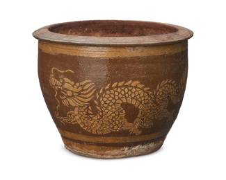 3258
An East Asian ceramic jardinière
19th century or later; China or Southeast Asia
The planter depicting a dragon motif in ochre and brown glazes
9.5" H x 12.625" Dia.
Estimate: $200 - $300