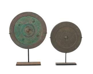 3183
Two Chinese bronze mirrors
Warring States through Han Dynasty (475 BCE-220 CE) or style
Each circular mirror with central knop surrounded by stylized scrolls or geometric motifs, set in an enameled metal stand
2 pieces
Larger mirror: 6.25" Dia. Smaller mirror: 5.25" Dia.; Larger overall: 8.875" H
Estimate: $400 - $600