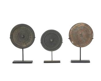 3182
Three Chinese Bronze mirrors
Warring States through Han Dynasty (475 BCE-220 CE) or style
The largest with a ring of stylized script, the next with two scrolls flanking a small knop, the last with a ring of stylized script within chevron band, each set in an enameled metal stand
3 pieces
Largest: 4" Dia.; Smallest: 3.5" Dia.
Estimate: $400 - $600