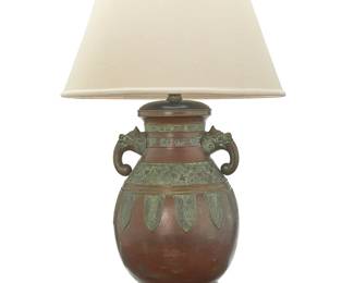 3237
A Southeast Asian brass archaistic vessel mounted as a lamp
Meiji/Taisho Period (1868-1926)
Likely Japanese, the patinated brass vessel with opposed figural handles, banded meandering and ocean wave motifs, and fish to body, mounted as a two-light lamp surmounted by a fabric and paper shade, electrified
Vessel: 18.5" H x 13" Dia.; Shade: 14.5" H x 22.5" Dia.
Estimate: $500 - $700