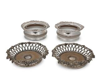 3056
Two pairs of silver-plated wine bottle coasters
19th/20th century
One pair with maker's marks of Elkington, Mason & Co., Birmingham, dated for 1859; also bearing an armorial at center
Comprising an Elkington pair, each with a circular grapevine rim over incurved pierced latticework walls on a wood-inset base, and another pair from an unknown maker with wood inset base
4 pieces
Elkington: 2" H x 8.125" Dia.; Unmarked: 3" H x 7" Dia.
Estimate: $400 - $600