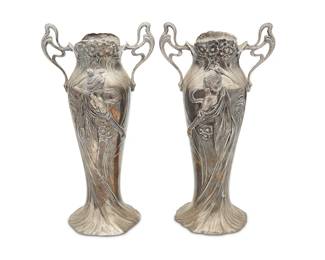 3054
A pair of WMF Jugendstil pewter vases
Early 20th century
Each marked for WMF
The vases with open bottoms and opposed handles, each featuring opposed maiden figures in high relief surrounded by flowers
2 pieces
Each: 14.5" H x 7.75" W x 6.25" D
Estimate: $600 - $800