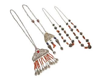 3327
A group of vintage coral and silver tribal-style necklaces
Comprising two North African openwork silver and coral pendant necklaces, each with various multiple dangles in silver, and coral, and one with Venetian "millefiori" as well as blue glass beads, together with two likely Central Asian single strand necklaces with chunky coral and two-tone enamel metal beads
4 pieces
Largest: 27.5" L x 6" H; Smallest: 27" L
456.7 grams gross
Estimate: $100 - $200