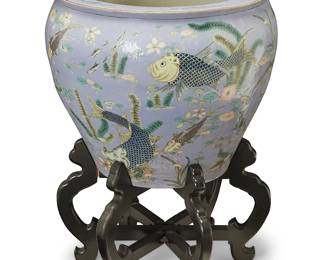 3141
A Chinese polychrome porcelain fish bowl
20th/21st century
The exterior depicting carp on a lavender ground, the interior depicting goldfish and underwater plants, set on a foldable ebonized wood stand
2 pieces
Bowl: 19.5" H x 24.75" Dia.: Stand: 15" H x 23.75" Dia.
Estimate: $200 - $400