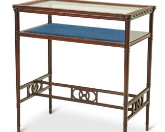 3098
A rosewood table vitrine
Mid-20th century
Furniture Stylists Inc. / Hoboken, N.J.
The glazed display case with hinged top and blue velvet-lined interior, raised on turned bamboo-form legs joined by a stylized H-stretcher with concentric circle accents
26.25" H x 25" W x 14.75" D
Estimate: $300 - $500
