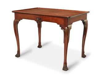 3096
An Irish George II-style mahogany table
Late 19th/early 20th century
The tabletop with raised edges, raised on curvilinear legs ending in pad feet, featuring scallop shell accents to apron
28" H x 37.75" W x 25.25" D
Estimate: $400 - $600