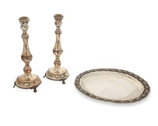 3016
A pair of sterling silver candlesticks and an oval tray
20th century
Each marked for sterling
Possibly Hazorfim, comprising a pair of candleholders with swag motif accents raised on a filigree-adorned tripartite base, and an oval tray with repoussé floral motif rim
3 pieces
Each candlestick: 10" H x 3.75" Dia.; Tray: 10.875" W x 8.25" D
Total weight: 16.1 oz. troy approximately
Estimate: $200 - $300