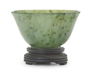 3170
A Chinese carved nephrite cup
20th century or earlier
Set on a wood stand
Cup: 1.375" H x 2.375" Dia.; Stand: 0.625" H x 1.5" Dia.
Estimate: $200 - $300