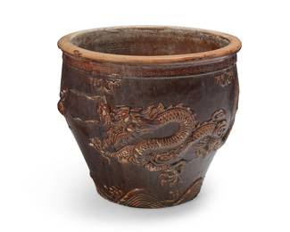 3257
An East Asian ceramic jardinière
19th century or later; China or Southeast Asia
The brown glazed jardinière depicting a dragon figure in relief
16" H x 18.5" Dia.
Estimate: $300 - $400