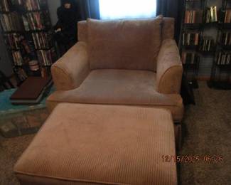 One of a pair of chairs with matching ottomans