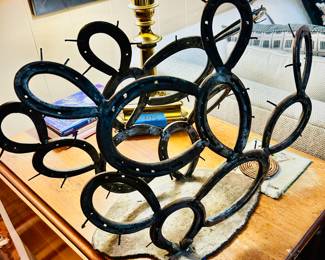 Forged metal cactus wine holder made from horseshoes