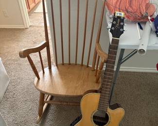 Takamine guitar model EG540sc and vintage rocking chair.