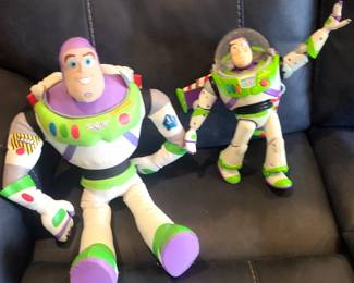 The image displays two Disney Store Official Buzz Lightyear Interactive Talking Action Figures. 




The figures are based on the character from the Disney and Pixar Toy Story films. 
They feature multiple points of articulation for posability. 
The larger figure is approximately 12 inches tall. 
They can say multiple phrases and sounds, and interact with other Toy Story interactive characters. 