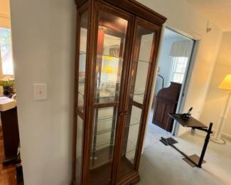 P22 - $225. American of Martinsville Lighted Display Cabinet. Measures 31" wide x 12.5" deep x 74" tall. 4 glass shelves are all adjustable.