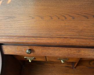 P25 - $150. Roll Top Wooden Desk. Measures 42" wide x 22" deep x 47" tall. Solid wood - Roll top closes easily.
