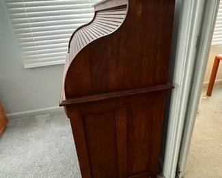 P25 - $150. Roll Top Wooden Desk. Measures 42" wide x 22" deep x 47" tall. Solid wood - Roll top closes easily.