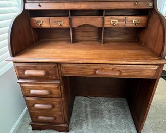 P25 - $150. Roll Top Wooden Desk. Measures 42" wide x 22" deep x 47" tall. Solid wood - Roll top closes easily.