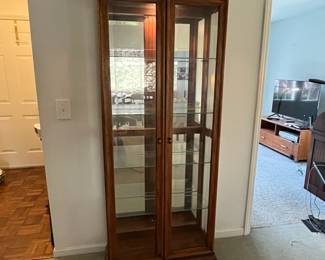 P22 - $225. American of Martinsville Lighted Display Cabinet. Measures 31" wide x 12.5" deep x 74" tall. 4 glass shelves are all adjustable.