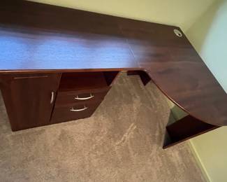 P31 - $30. Office Desk. In good condition and sturdy! Measures 58" long x 19.5" deep on one side and 39" deep on the larger side.