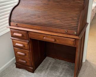 P25 - $150. Roll Top Wooden Desk. Measures 42" wide x 22" deep x 47" tall. Solid wood - Roll top closes easily.