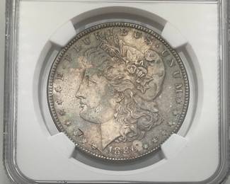 1886 Morgan Dollar, graded MS 63 by Numismatic Guaranty Company.