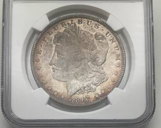1887 Morgan Dollar, graded MS 64 by Numismatic Guaranty Company.