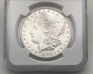 1883 Morgan Dollar, graded MS 63 by Numismatic Guaranty Company.