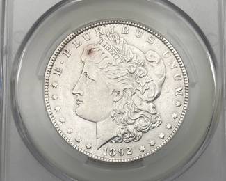 1892 Morgan Dollar, graded AU Details by CAC. Harshly Cleaned.