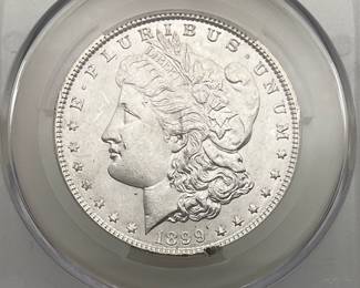 1899 Morgan Dollar, graded UNC Details by CAC. Damage, rim.