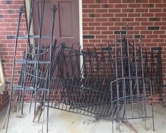 Several Pieces Of Black Metal Garden Fencing And Trellises
