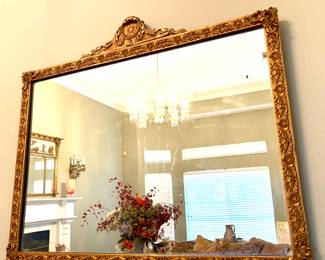This is a vintage Rococo Revival or French-inspired ornate wall mirror, measuring 31 inches tall by 25 inches wide $350