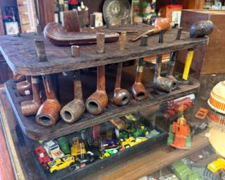 Vintage tobacco pipes with a wooden display stand
