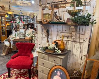beautiful red accent chair, brass planters, decanter, framed antique art