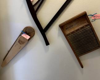 Antique saw, washboard and ironing board