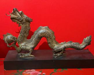 Chinese bronze dragon statue holding a flaming pearl