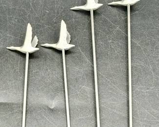 (4) Grey Goose olive picks and martini swizzle sticks