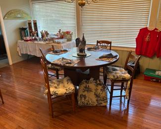 Amish made table with bin underneath, table will swivel up to expose bin underneath. Blue and white chair pads. All chairs are priced individually
